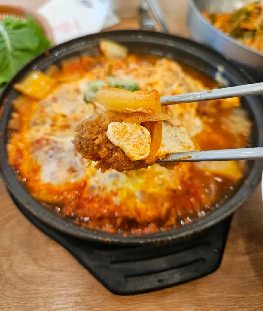Close-up of kimchi nabe broth and ingredients