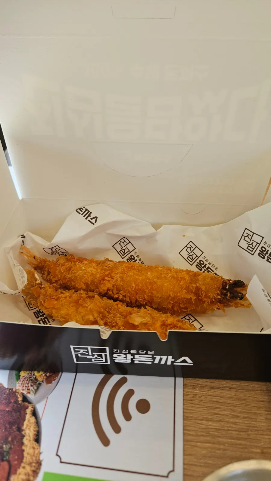 Leftover fried shrimp packed into a takeout box