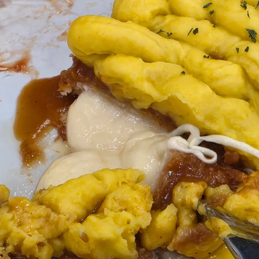 Sweet potato cheese pork cutlet with cheese pouring out after being cut in half
