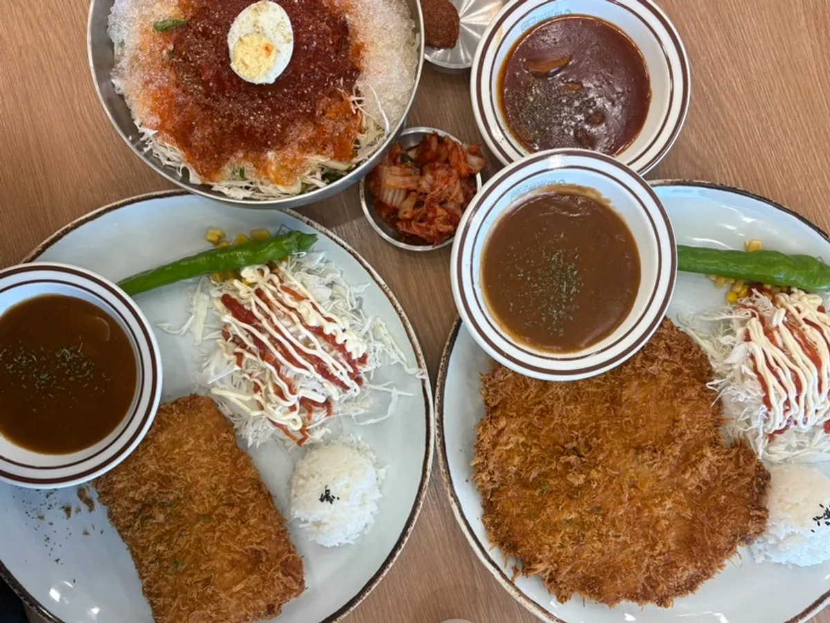 Table spread of Jinsim King Donkatsu, Cheese Waterfall Donkatsu, and cold jjolmyeon