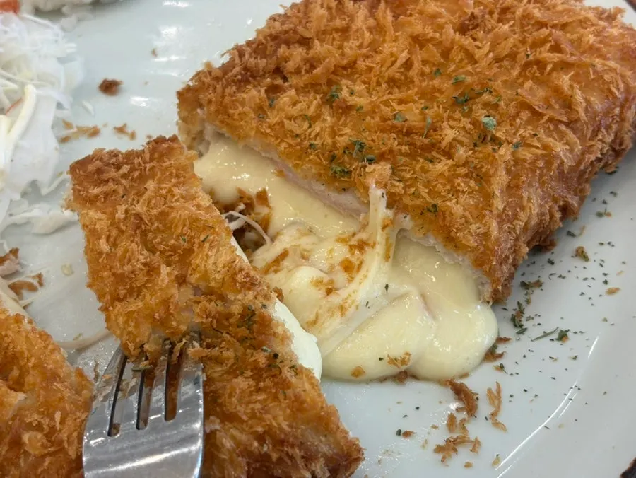 Cheese pouring out of the Cheese Waterfall Donkatsu