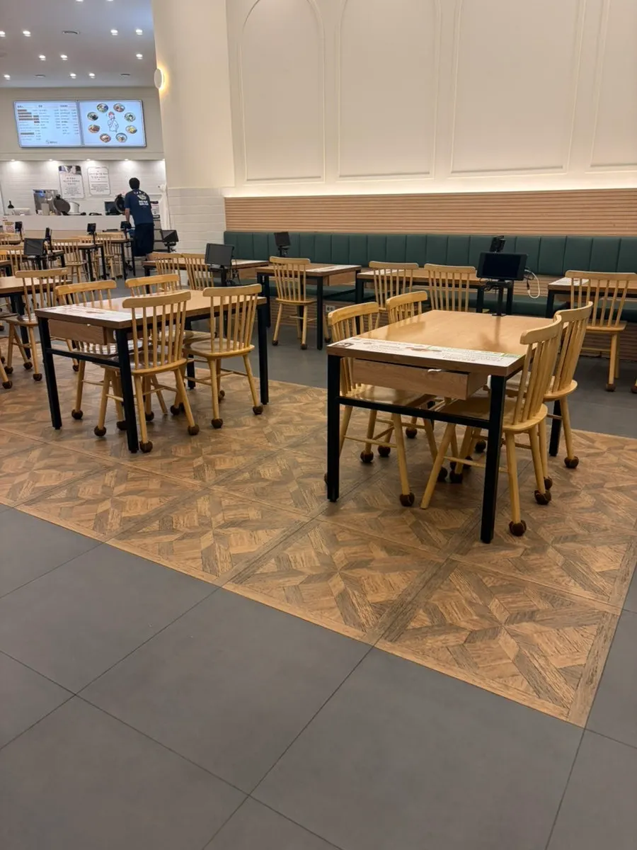 Interior of Jinsimwang Donkatsu Seogwangju Branch with roomy table spacing