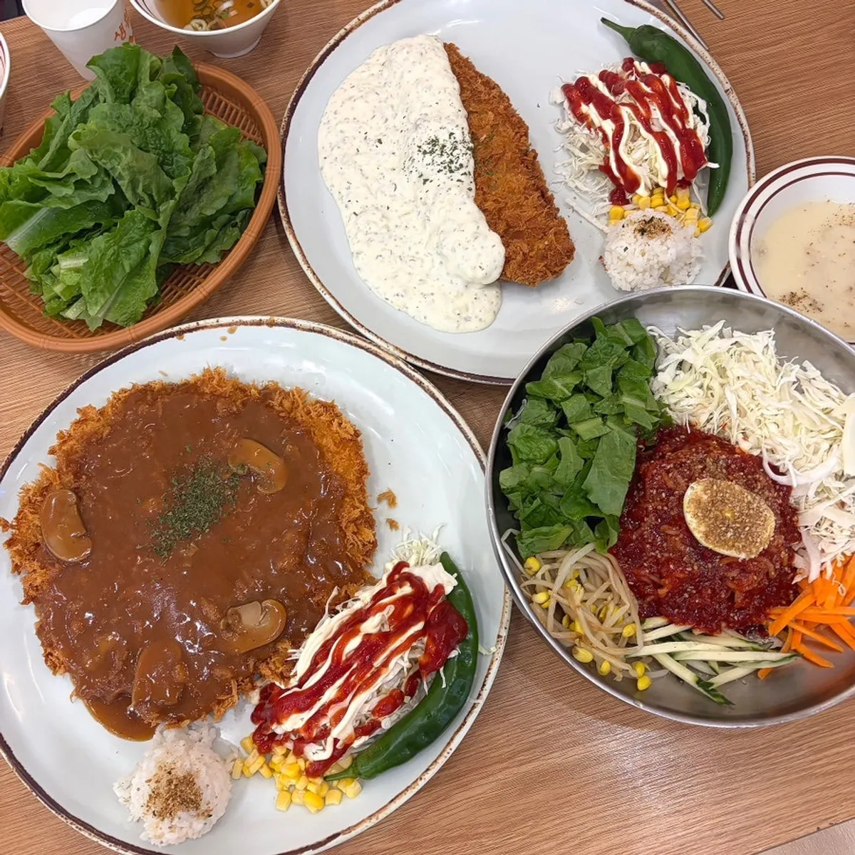 Self bar corner stocked with kimchi, danmuji, soup, and lettuce