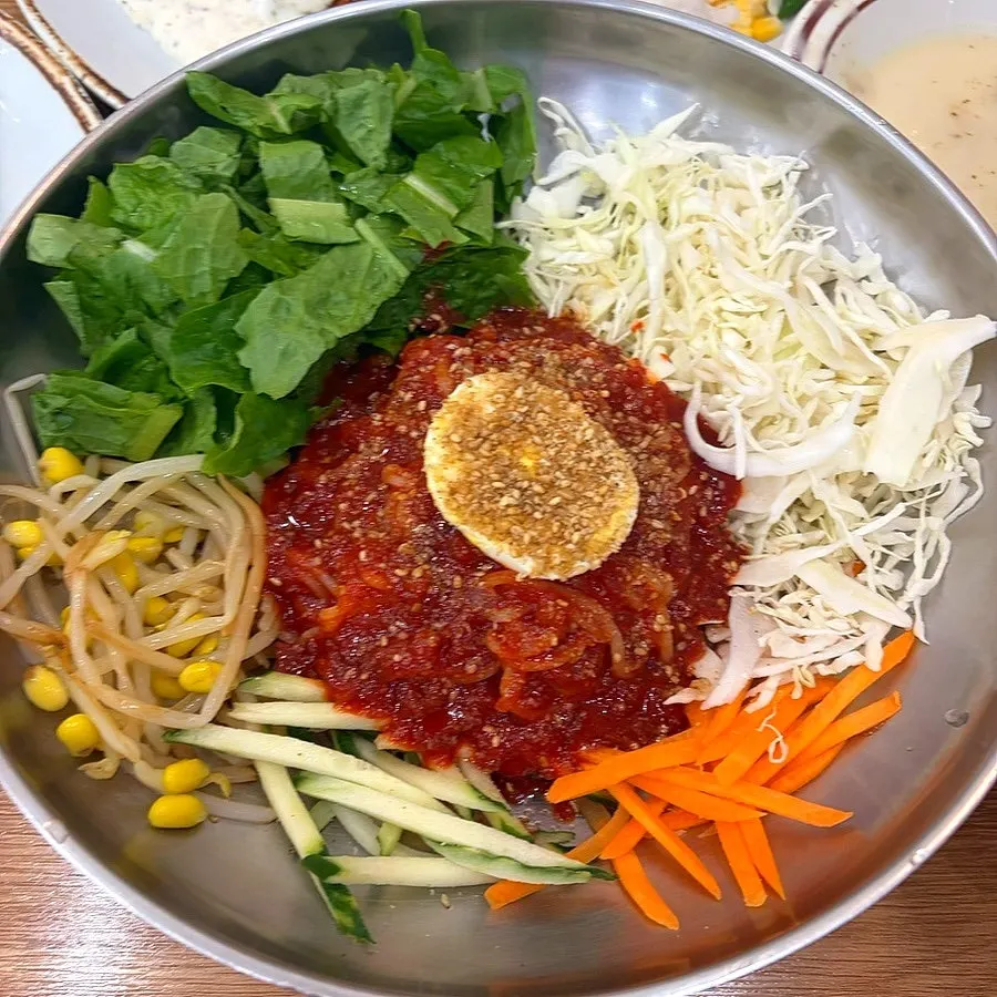 A bowl of jjolmyeon served alongside the tonkatsu