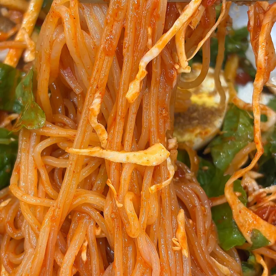 Tangy, spicy jjolmyeon noodles tossed and ready to eat