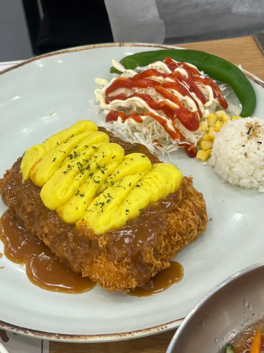 Cross-section of sweet potato cheese tonkatsu with cheese flowing out right after cutting