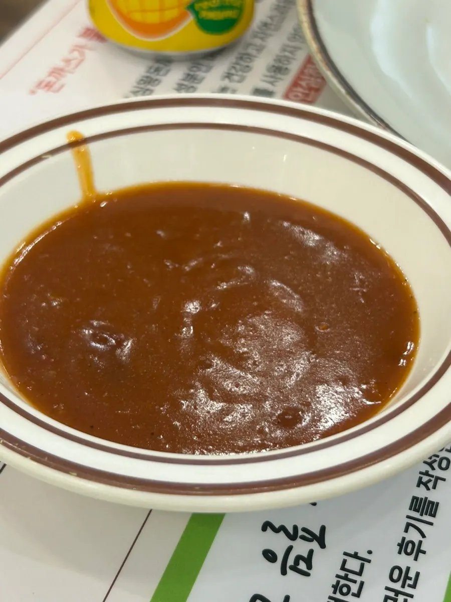 A piece of tonkatsu showing thick meat and crispy breading