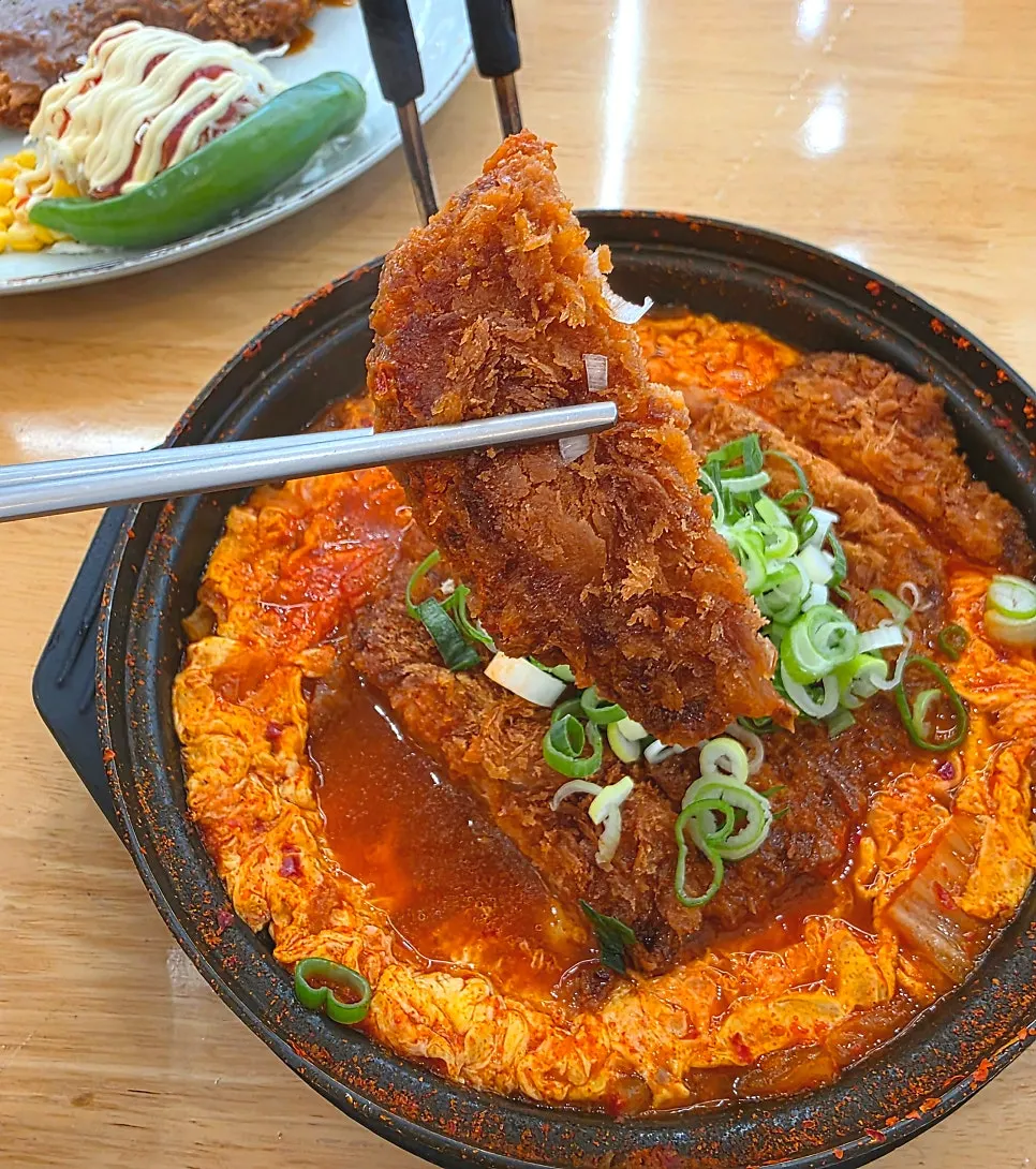 A piece of cutlet made moist from soaking up the broth