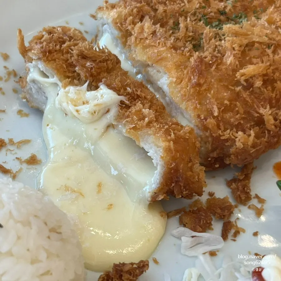 Cheese pouring out as the Cheese Waterfall Cutlet is cut