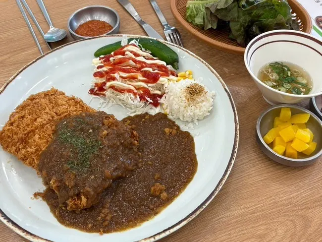 Table setting with rice, salad, and chili peppers