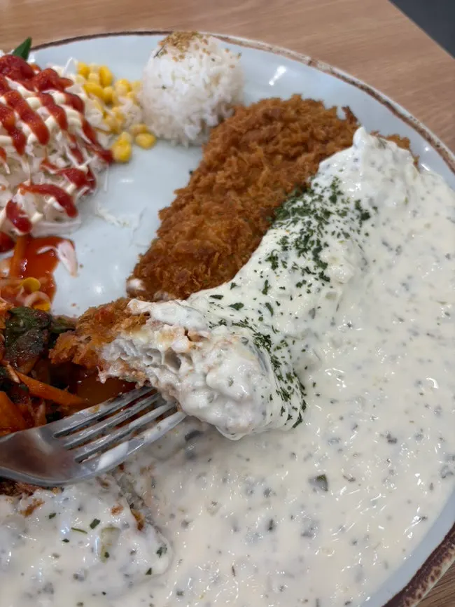 Fish katsu with jjolmyeon and tartar sauce drizzled on top