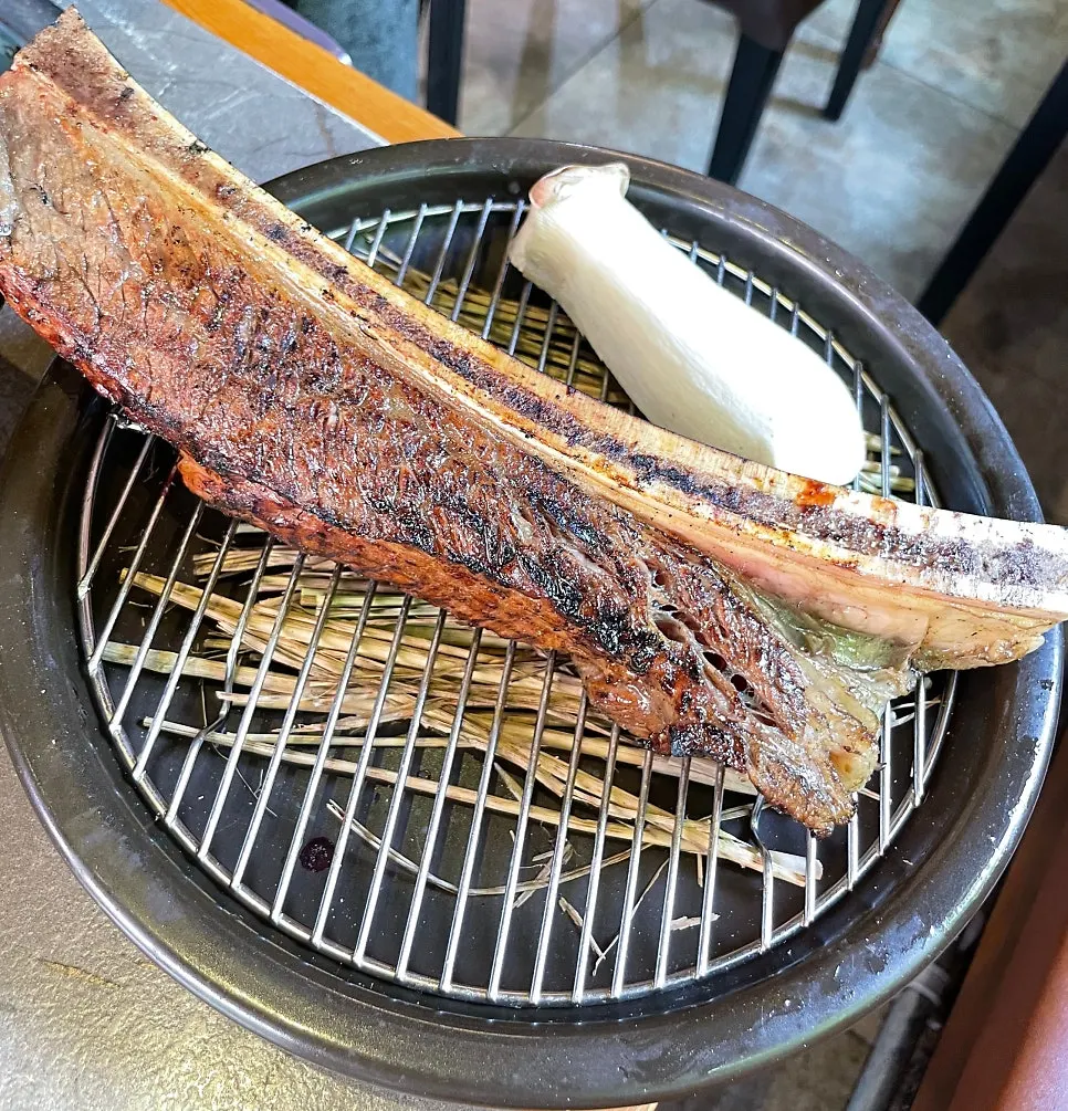 Bracken fern and kimchi placed on the grill