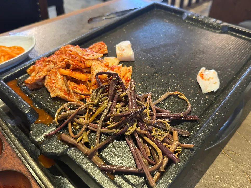 Table set with green onion kimchi, spicy radish salad, and other banchan