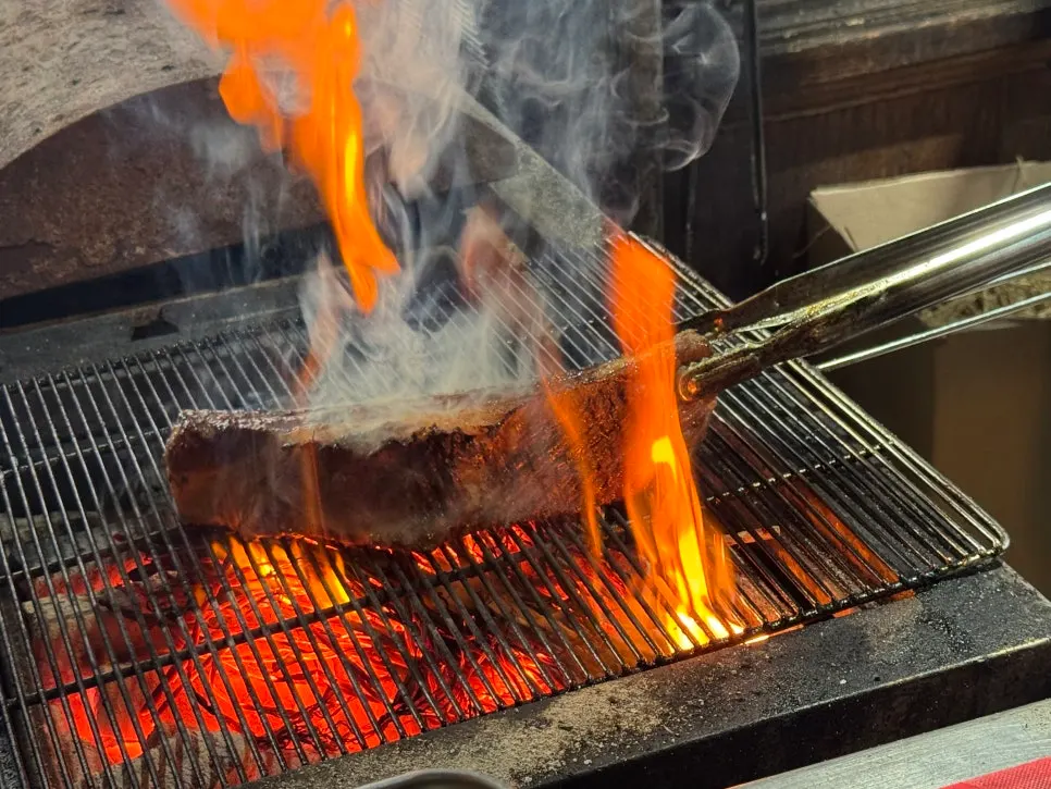 Flames rising during the straw-fire sear