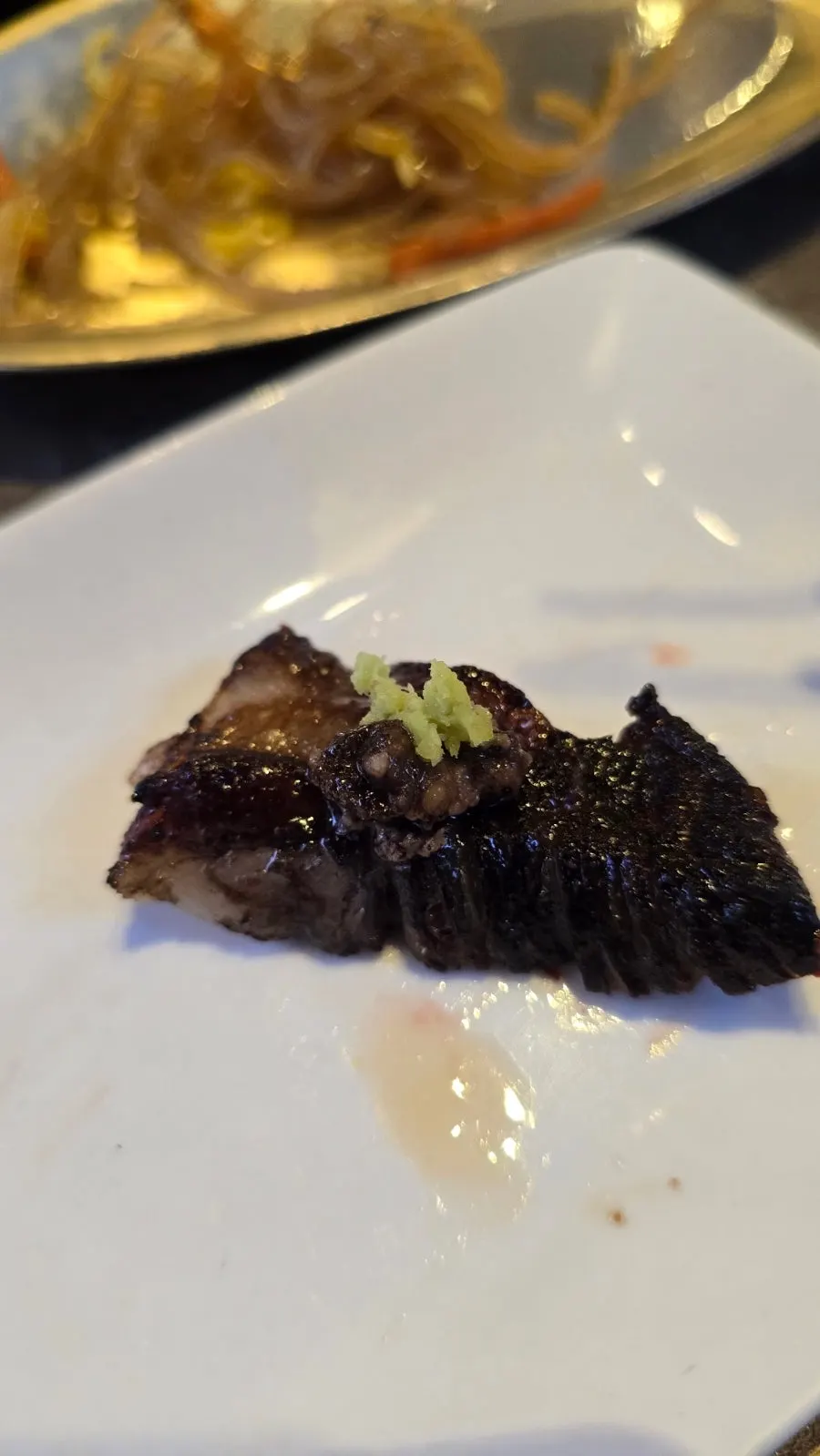Grilled udae galbi dipped in sauce