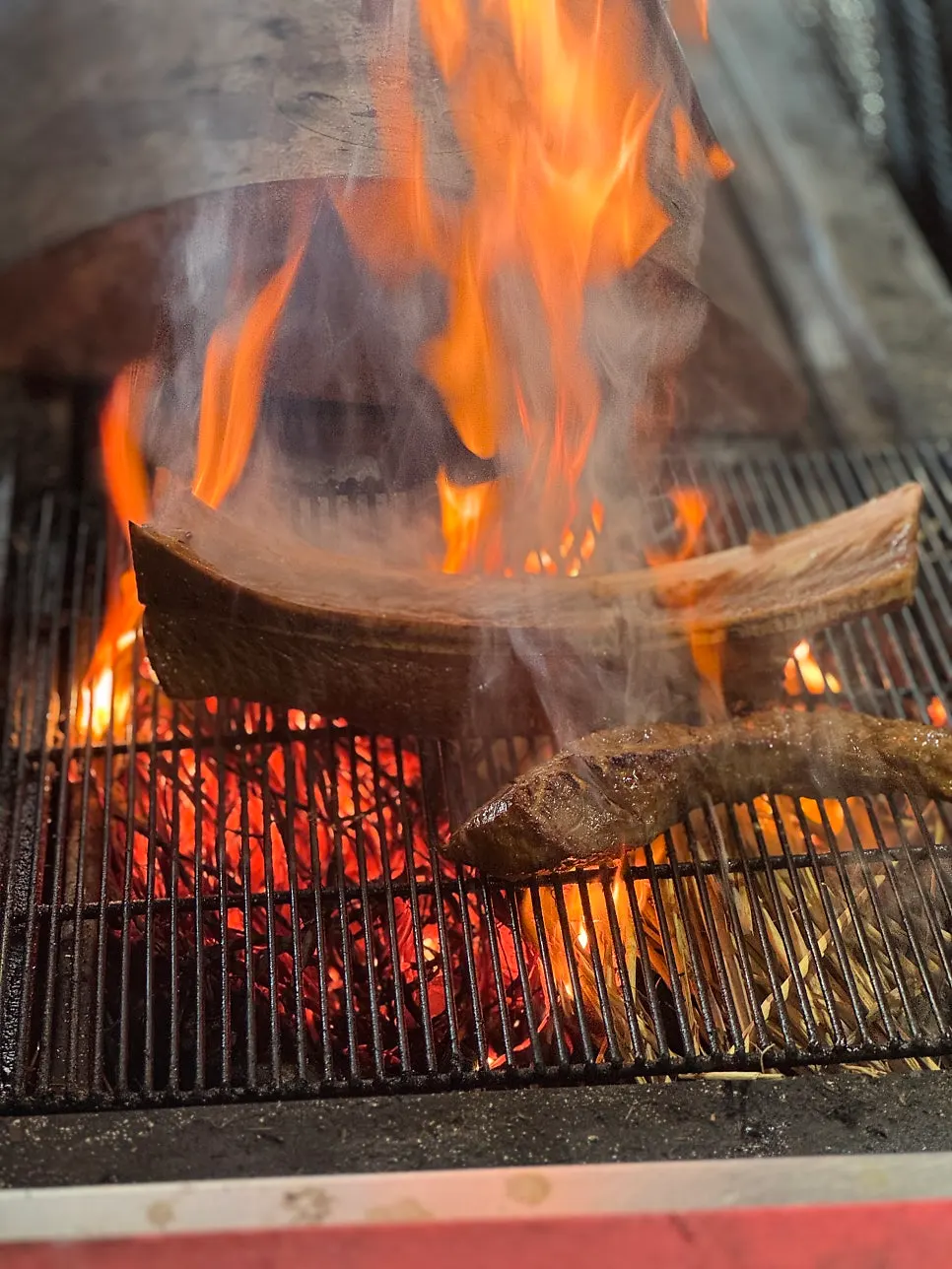 Table setting with uedae galbi pre-seared over straw fire