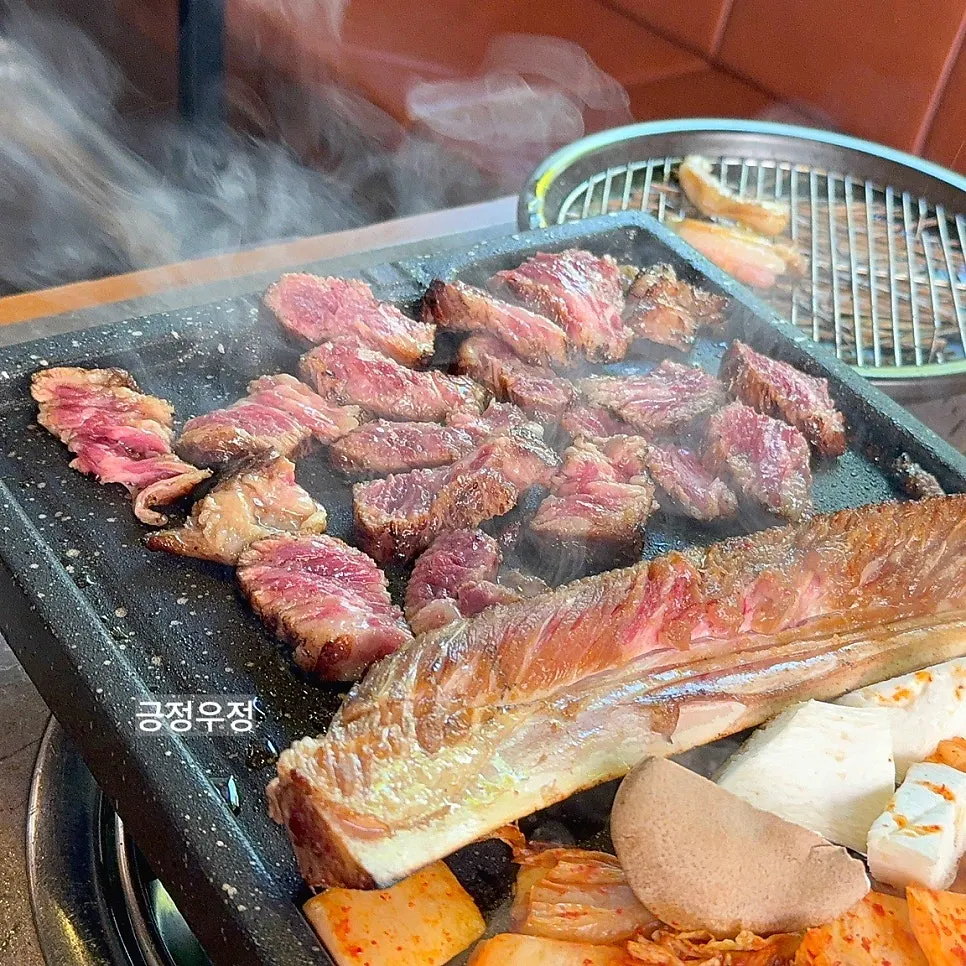 Fully grilled ribs placed on top of the bones on the grill