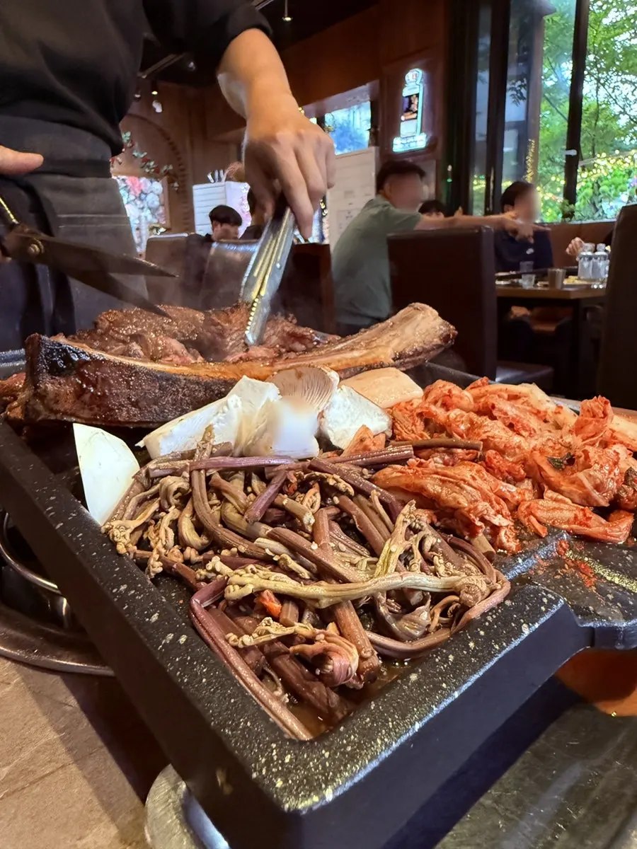 Marinated taebaek straw-fire grilled beef cooking on the grill
