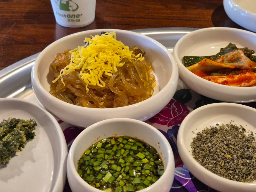 Side dishes including japchae and salad