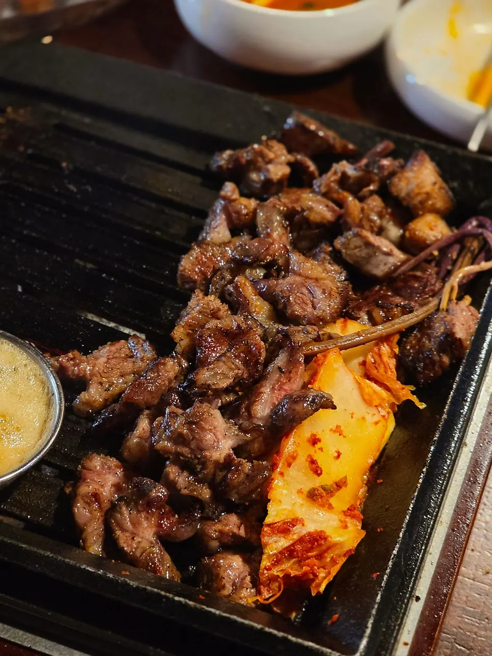 Second round of rib-bone meat being grilled