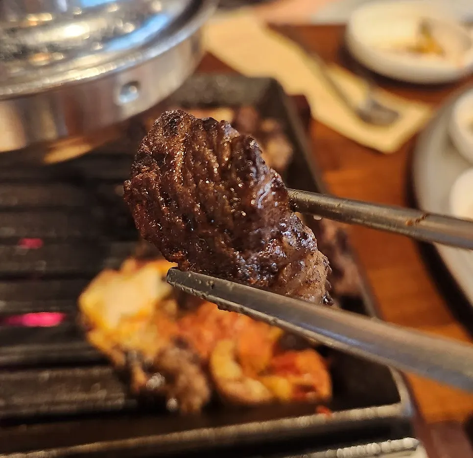 Meat topped with neungi mushroom pesto and black sesame salt