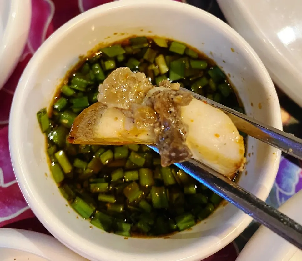 Dipping mushroom into neungi mushroom pesto