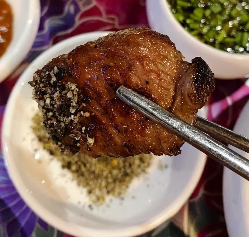 A piece of prime rib dipped in aged soy sauce