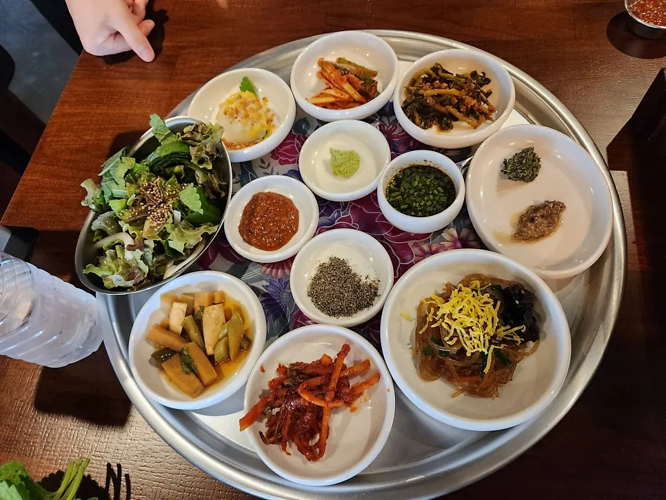 A spread of basic side dishes including japchae and pickled radish