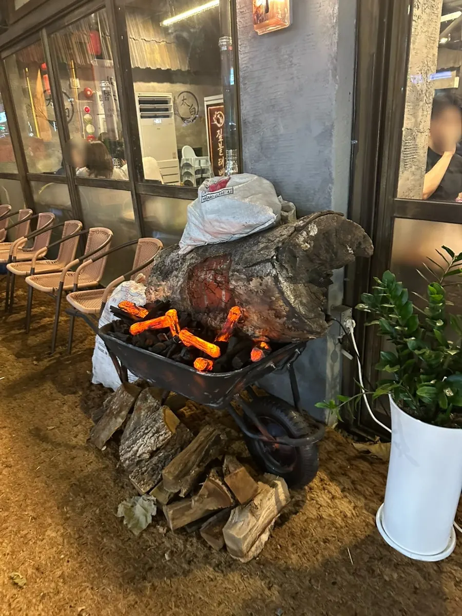 Storefront entrance with straw-fire-themed props