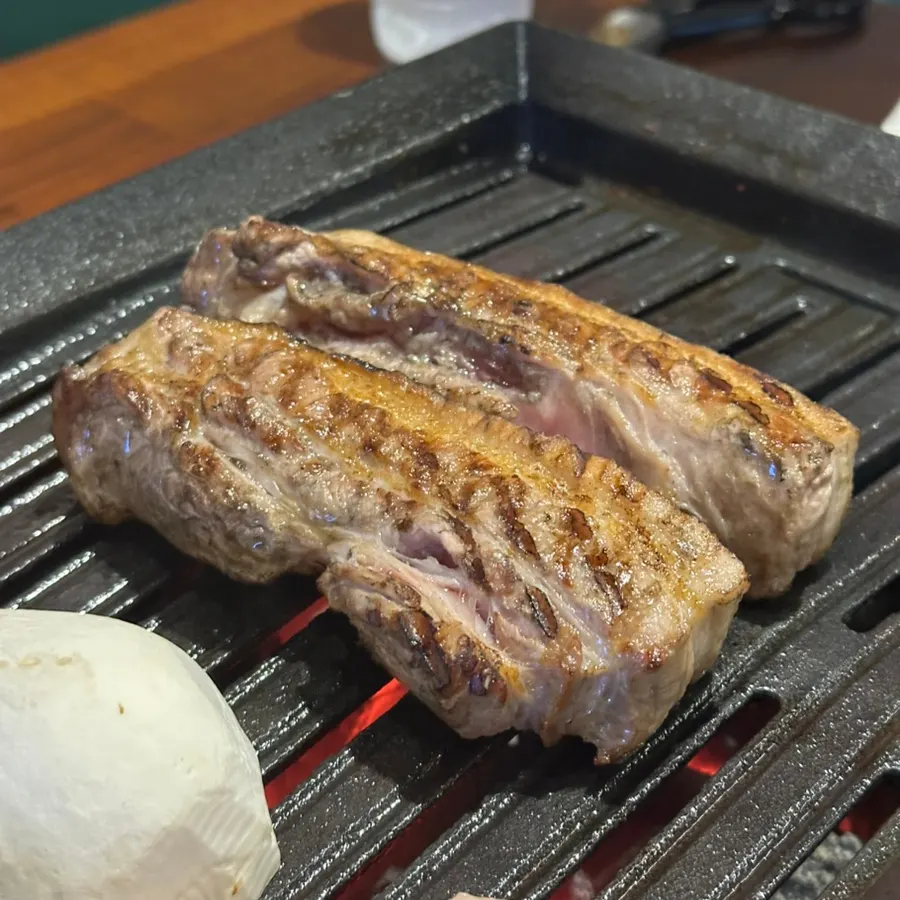 Straw-fired pork belly on the grill