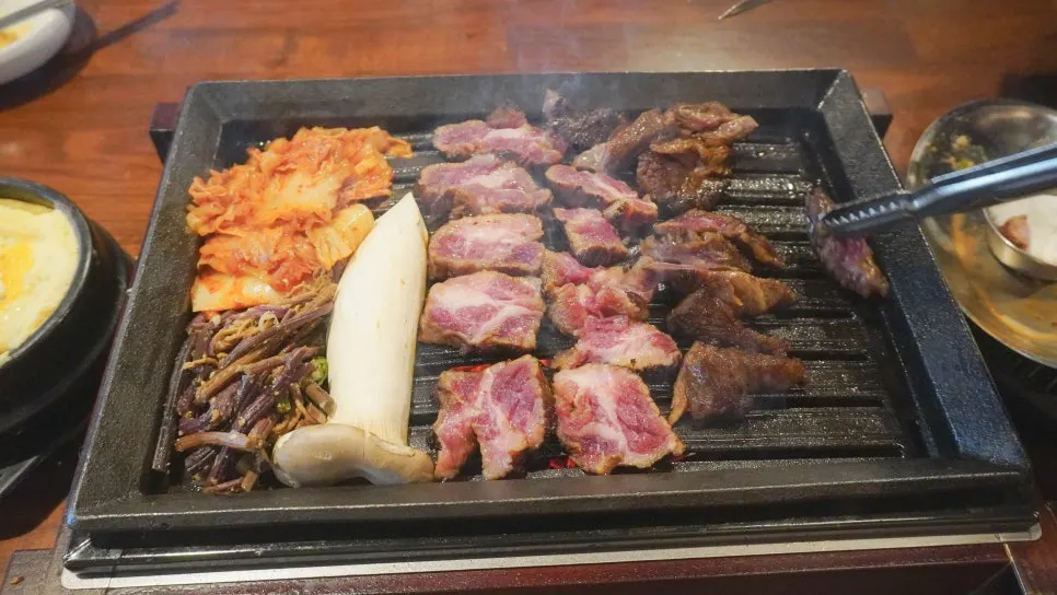 Pork jowl grilled tableside by staff