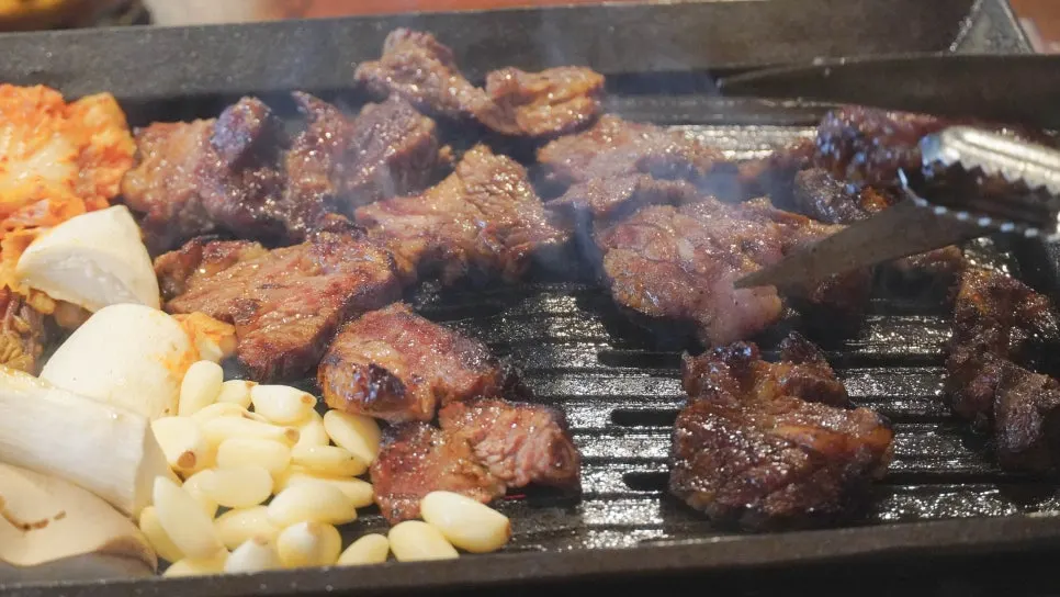 Cooked pieces moved to the side of the grill to avoid burning