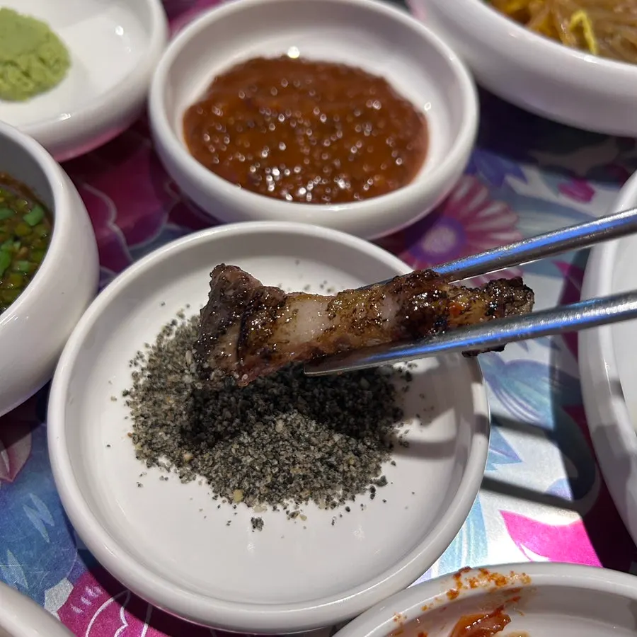 Plate of black sesame salt, fresh wasabi, and pesto sauces