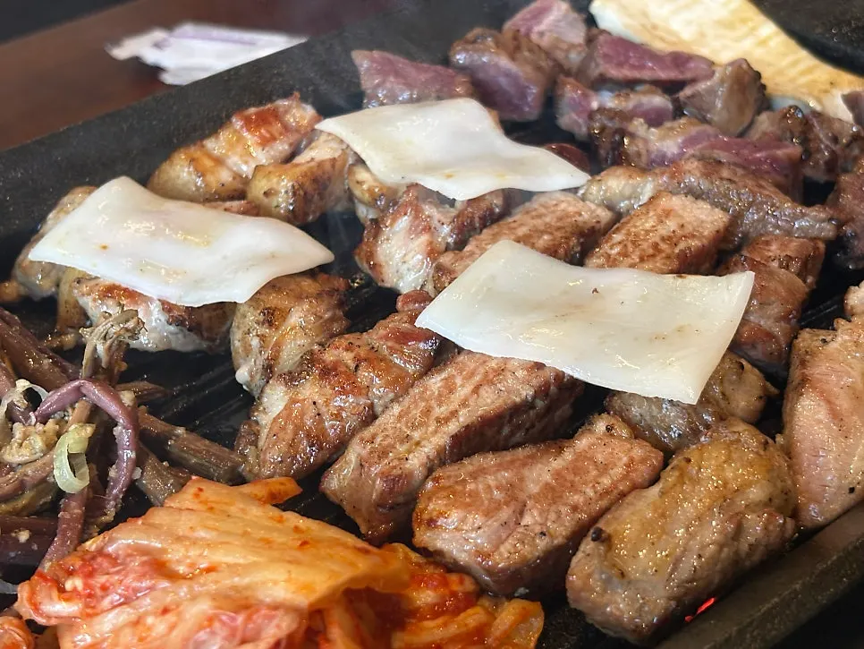 Meat and kimchi cooking on the grill