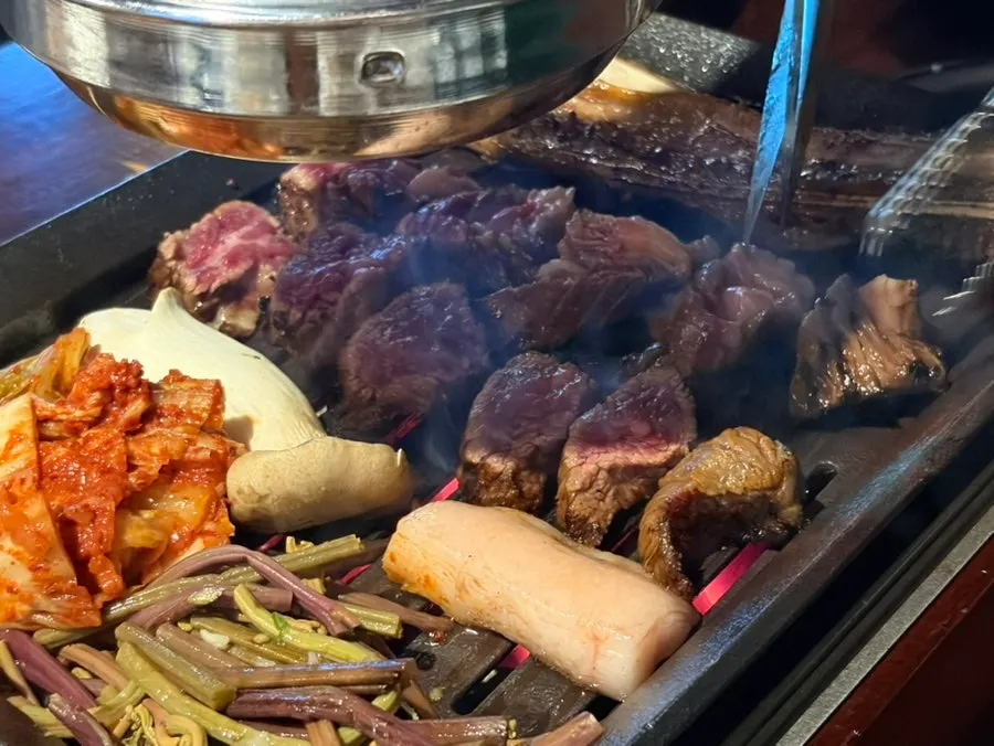 Staff member grilling the prime ribs