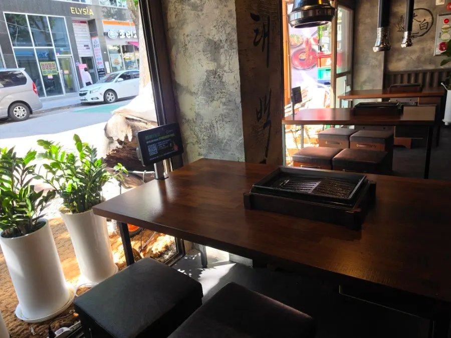 Table seating by the window with a view of the water garden