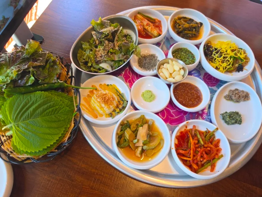 Basic table setting with banchan and dipping sauces on a silver tray