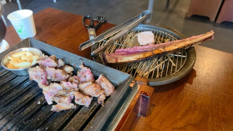 Second round of grilling the meat still attached to the rib bone