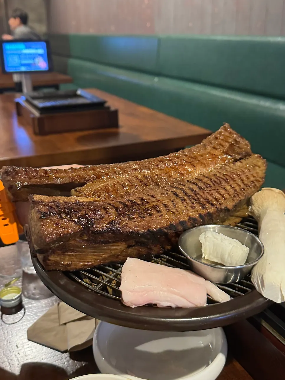 Straw-fired prime beef ribs arriving at the table