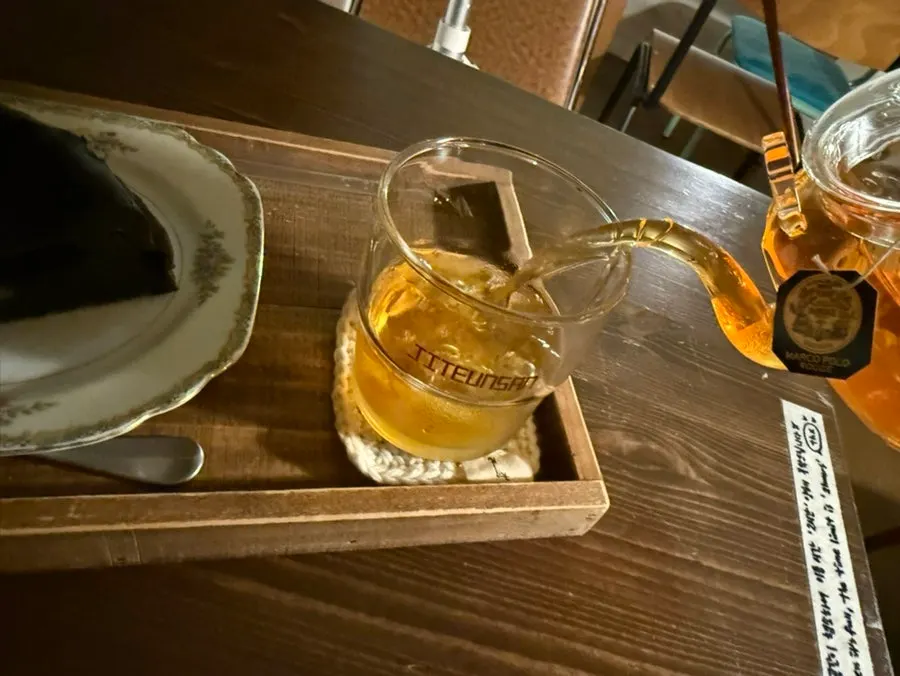 Close-up of the teapot with steeped Earl Grey tea bag