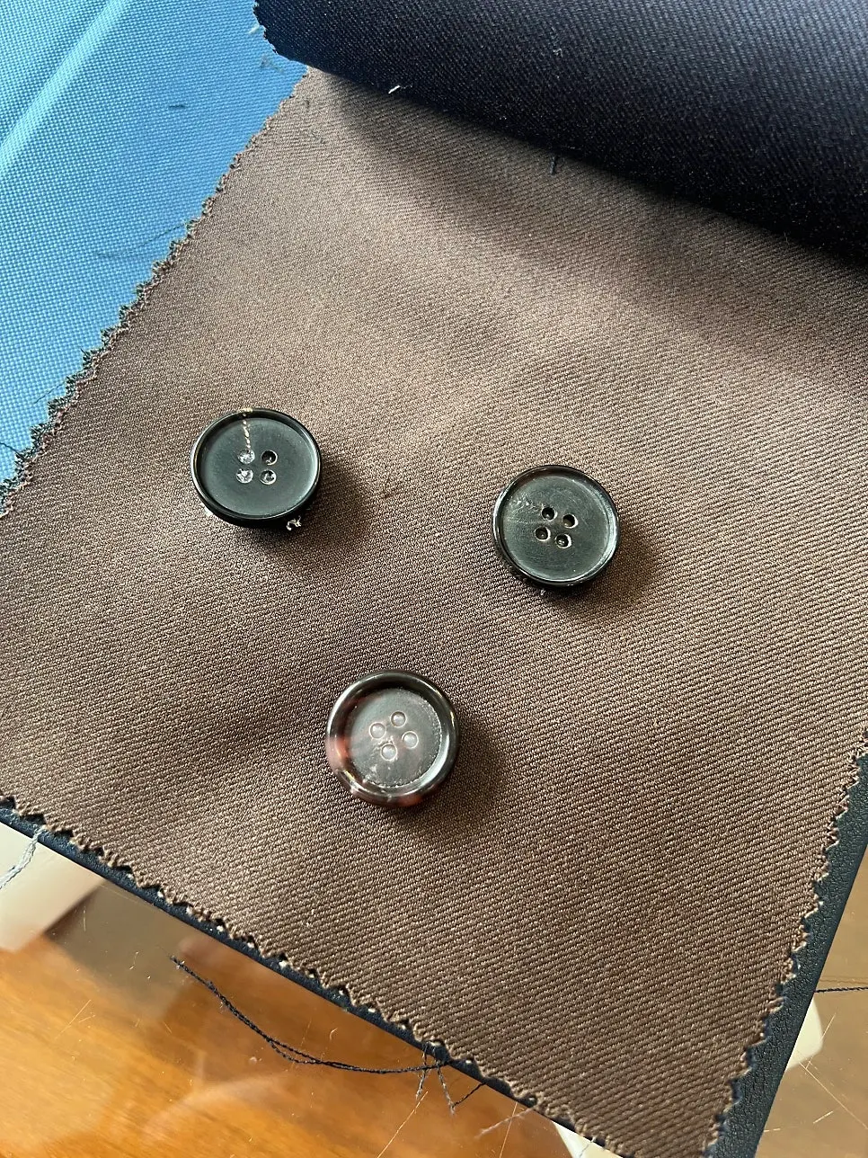 Comparing horn buttons laid on top of the fabric