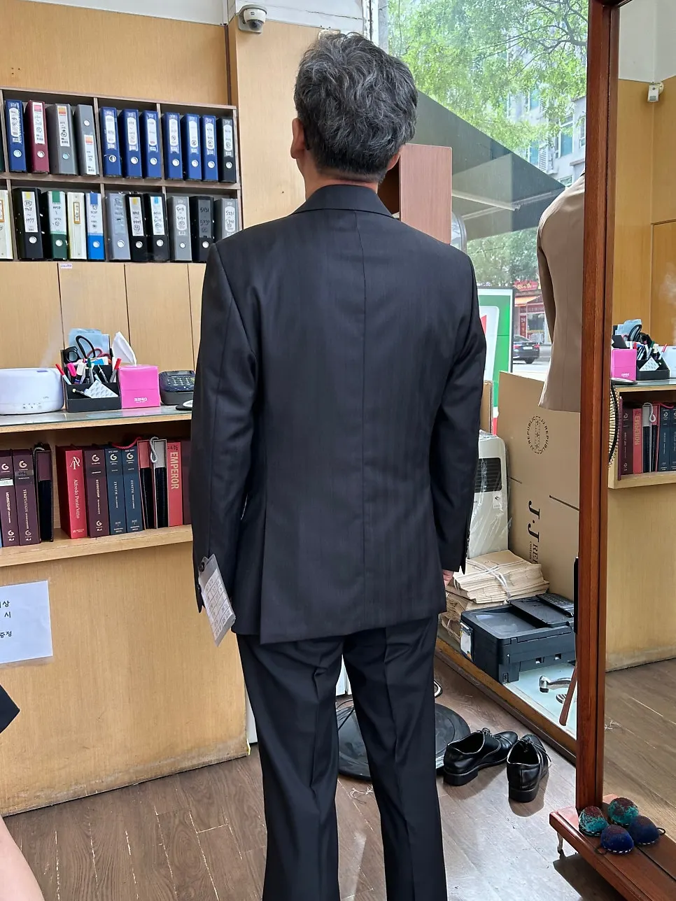 Checking the fit while wearing the custom jacket