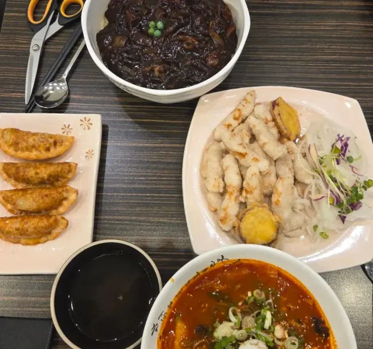 Table spread of the large jjajangmyeon, sujebi jjamppong and sweet rice tangsuyuk that were ordered