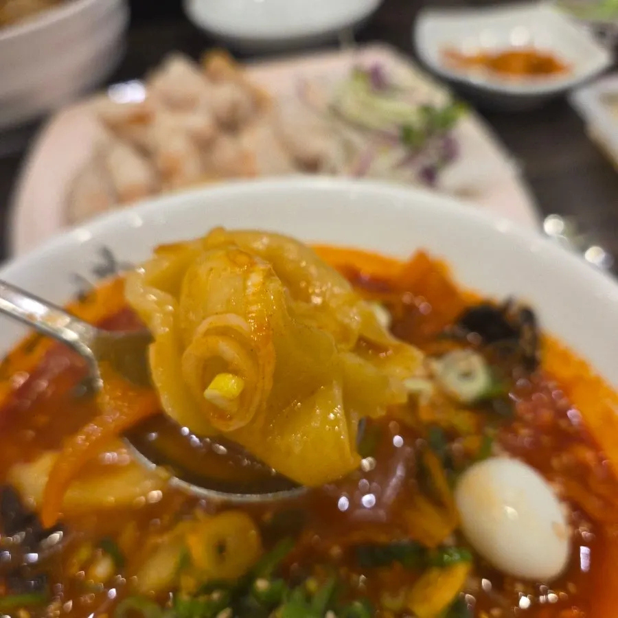 Close-up of the red broth of the sujebi jjamppong