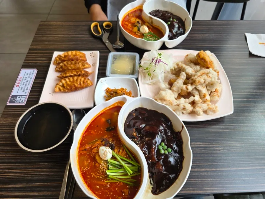 Sticky rice sweet and sour pork and jjamjjamyeon placed together on the table