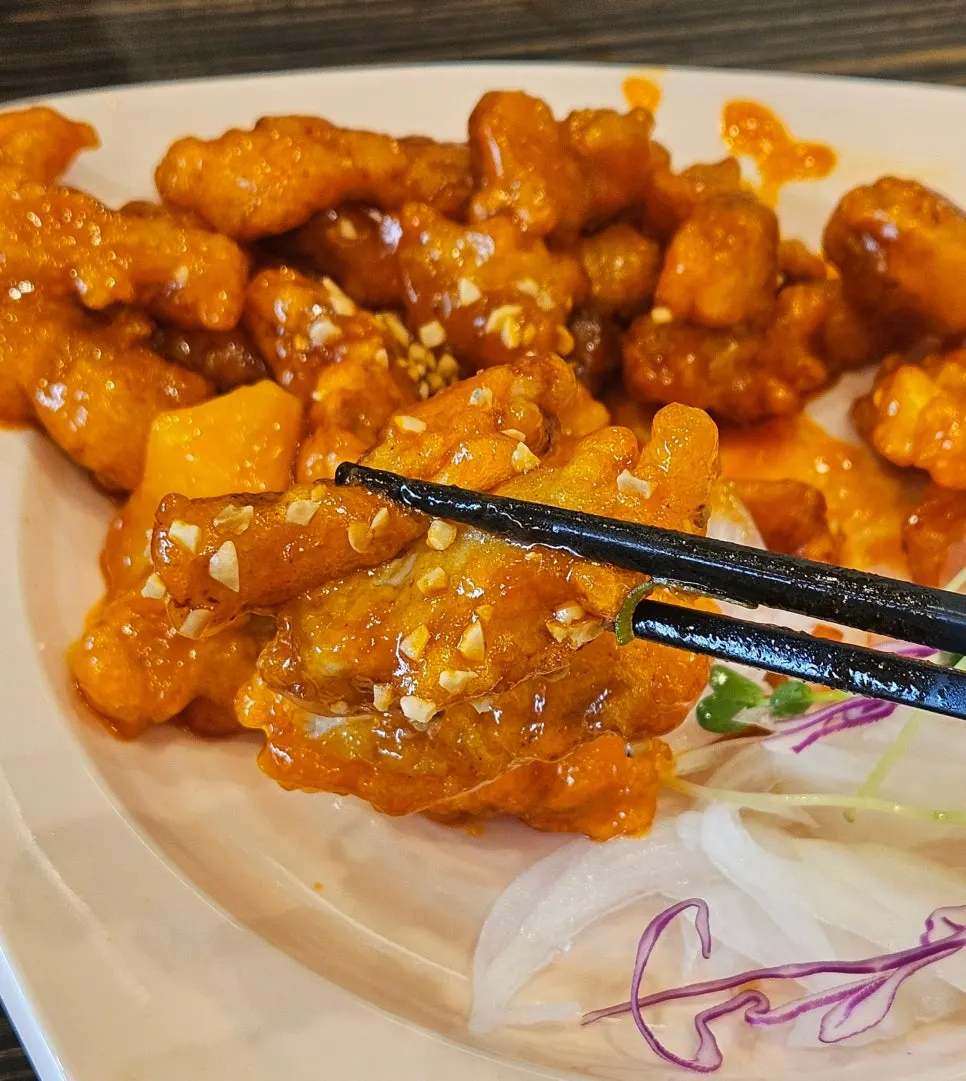 A plate of Sichuan tangsuyuk coated in sauce