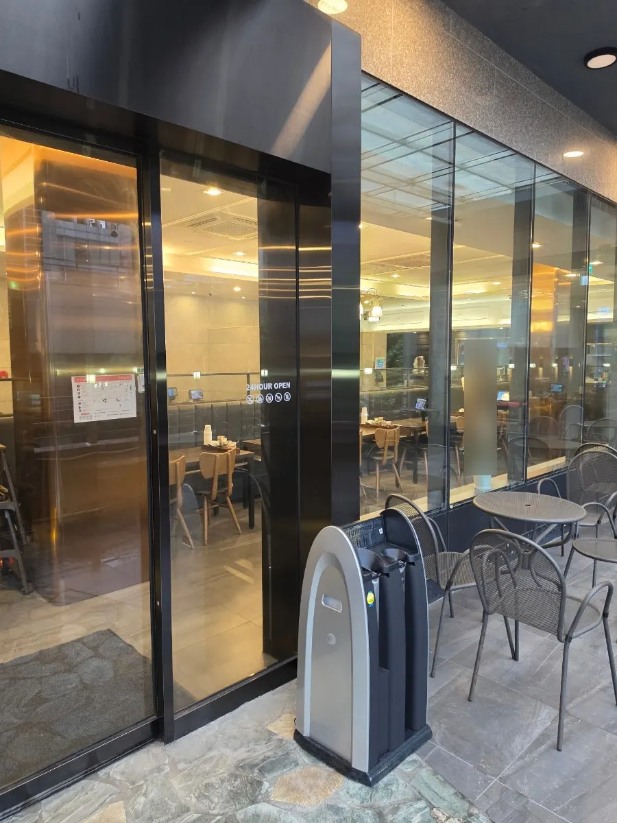 Parking lot in front of the building and sign for the 2nd-floor restaurant