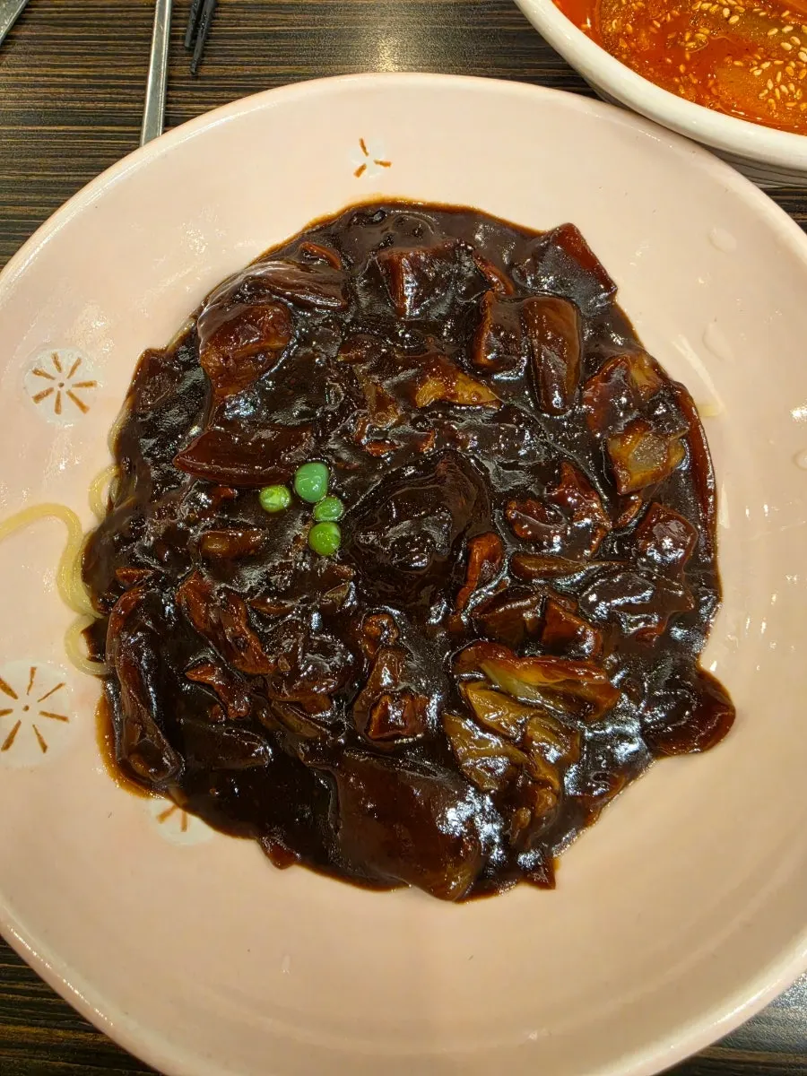Jjajangmyeon topped with a generous amount of black bean sauce