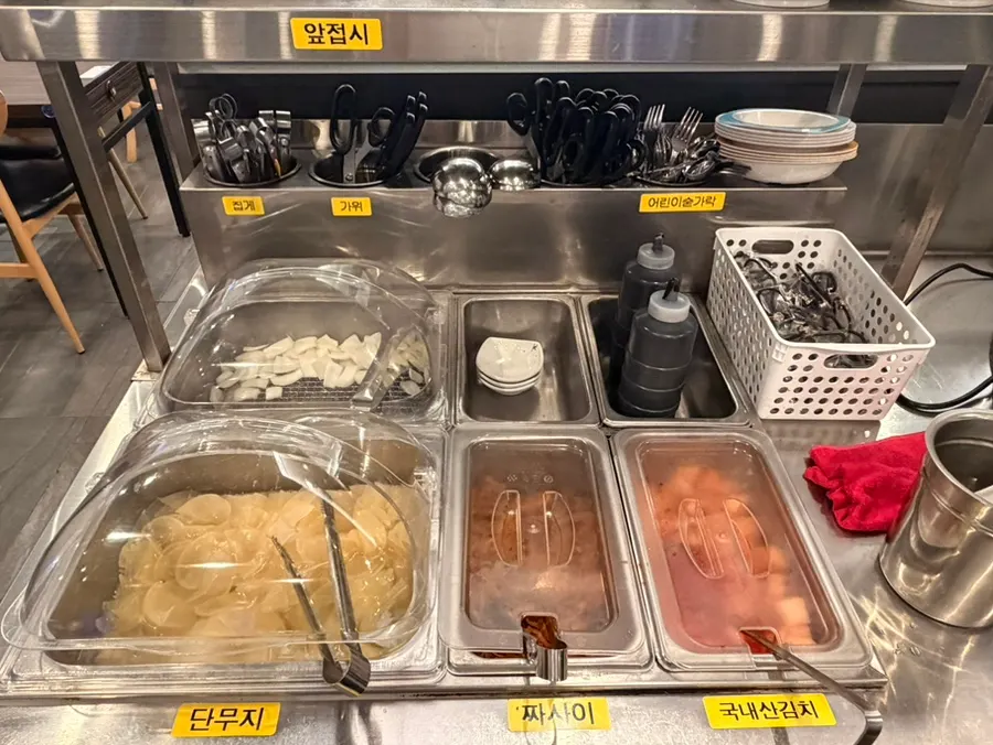 Stand with disposable aprons and individually wrapped hair ties