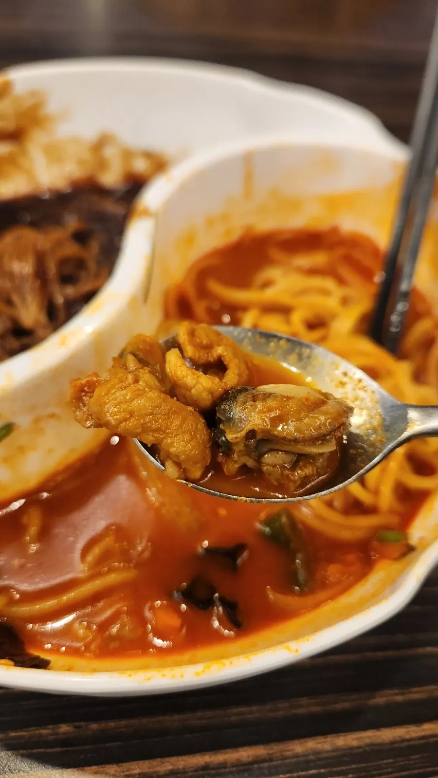 Jjamppong noodles lifted with chopsticks